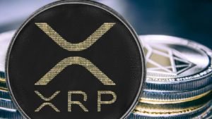 Coin cryptocurrency ripple on the background of a stack of coins